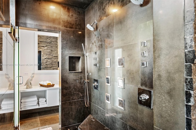 bathroom with tile walls and tiled shower