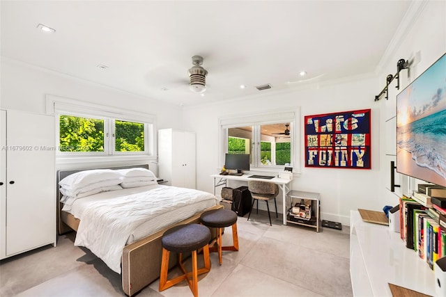 bedroom with crown molding, a barn door, multiple windows, and ceiling fan