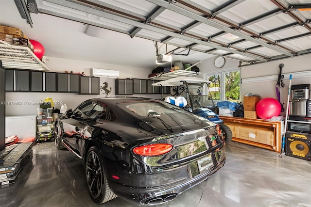 garage with a garage door opener and a wall mounted air conditioner