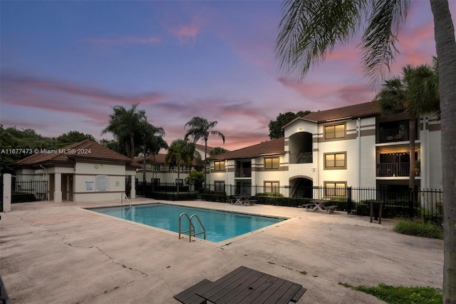 pool at dusk with a patio