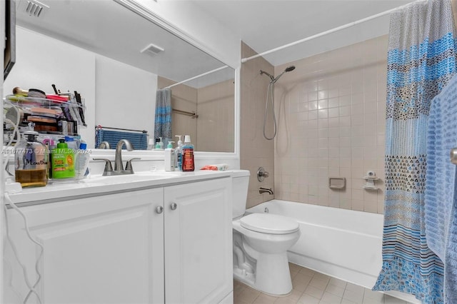 full bathroom featuring vanity, shower / bath combo with shower curtain, toilet, and tile patterned flooring