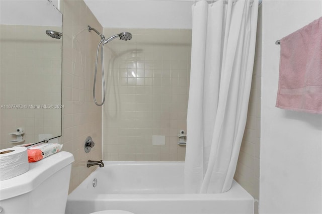 bathroom with toilet and shower / bath combo with shower curtain