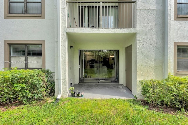 view of exterior entry featuring a patio area