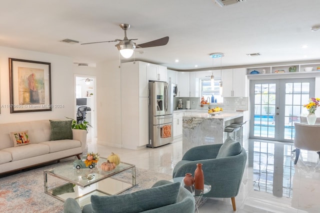 living room featuring french doors and ceiling fan