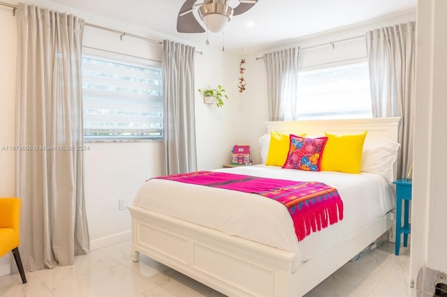 bedroom featuring multiple windows and ceiling fan