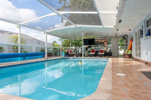 view of swimming pool with a patio and a lanai