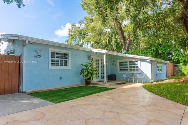 rear view of property featuring a patio and french doors