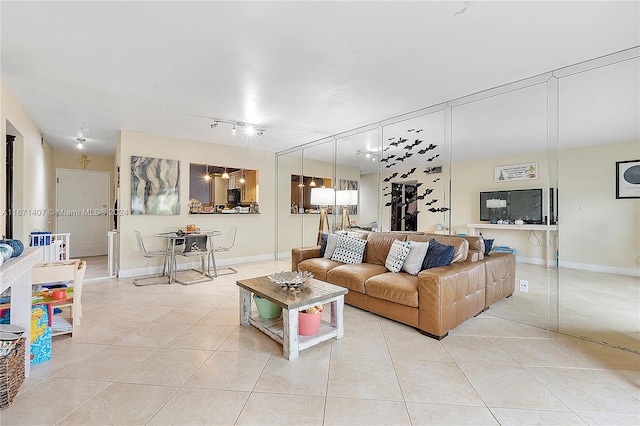 living room with rail lighting and light tile patterned floors