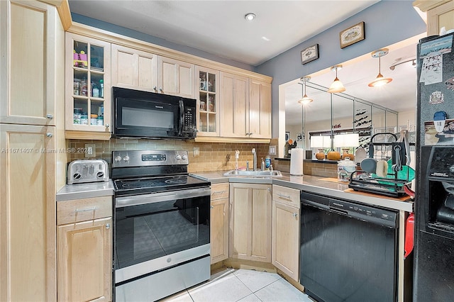 kitchen featuring light brown cabinets, light tile patterned floors, black appliances, sink, and decorative light fixtures