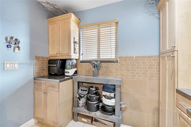 kitchen featuring light brown cabinets, decorative backsplash, and light tile patterned floors