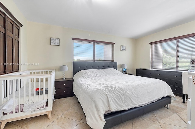 bedroom with light tile patterned floors