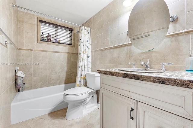 full bathroom featuring shower / tub combo, tile walls, toilet, vanity, and tile patterned floors