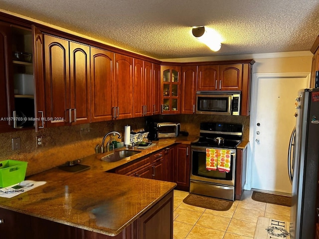 kitchen with kitchen peninsula, decorative backsplash, sink, crown molding, and stainless steel appliances