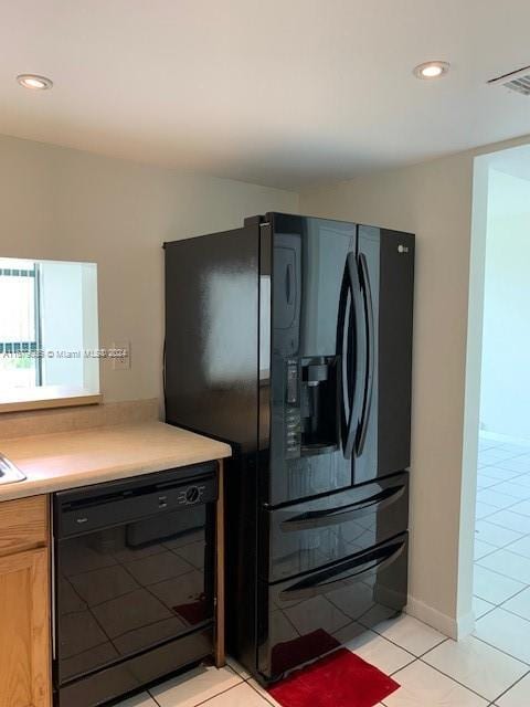 kitchen featuring black appliances, light tile patterned flooring, light countertops, and recessed lighting