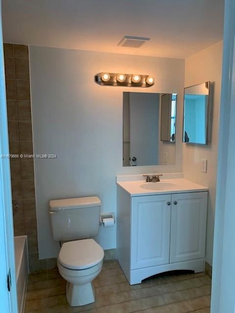 full bathroom featuring vanity, separate shower and tub, toilet, and tile patterned floors