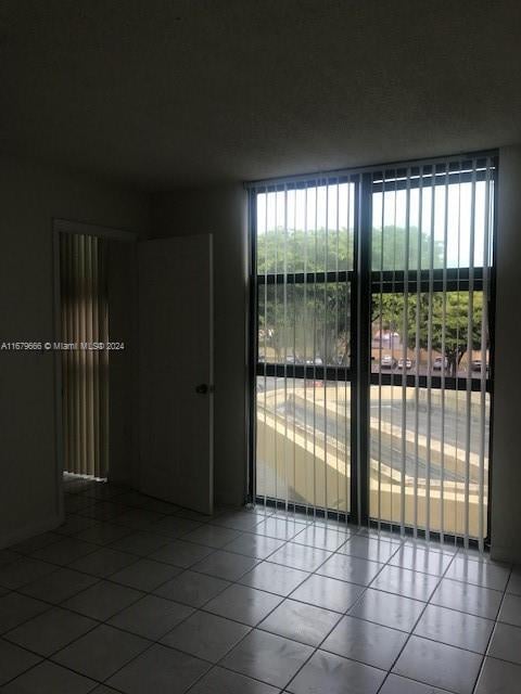 spare room with tile patterned flooring