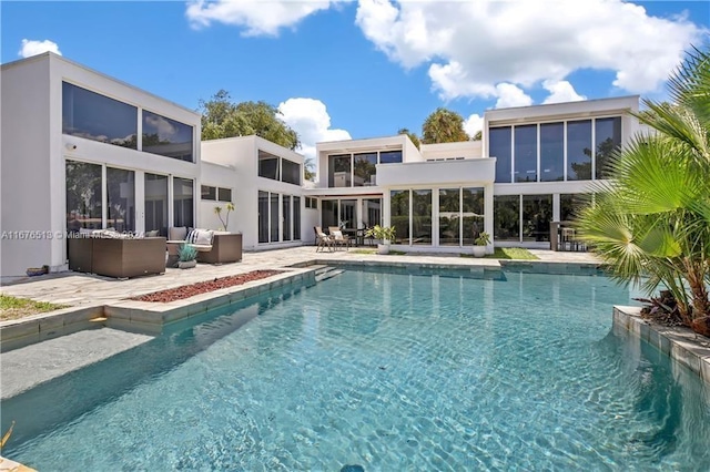 view of pool featuring a patio and a sunroom