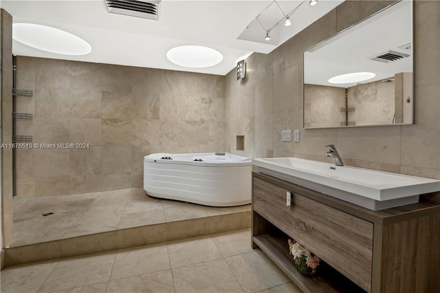 bathroom with vanity, tile walls, independent shower and bath, and tile patterned flooring