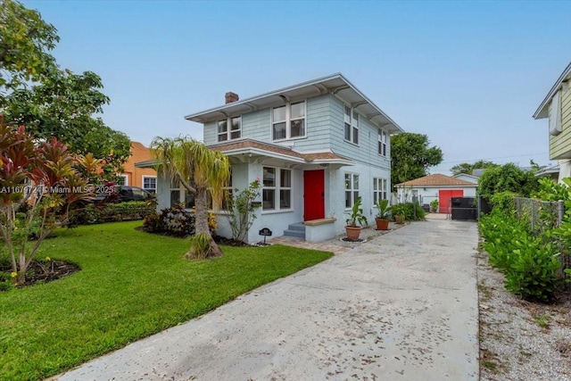 view of front of property with entry steps, a chimney, a front yard, and fence