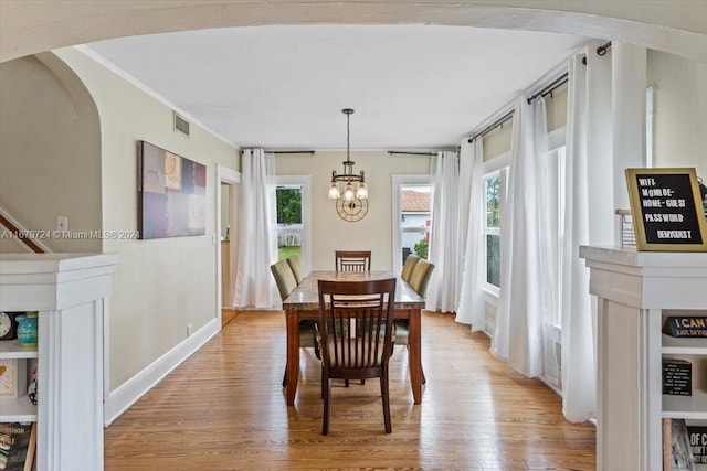 dining area with a chandelier, light hardwood / wood-style floors, and plenty of natural light