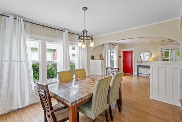 dining room featuring light hardwood / wood-style flooring, a notable chandelier, and plenty of natural light