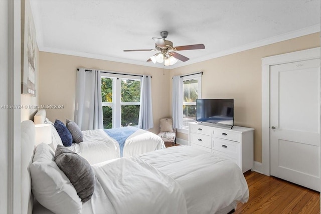 bedroom featuring ceiling fan, ornamental molding, and light hardwood / wood-style flooring