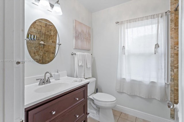 bathroom with vanity, toilet, tile patterned floors, and a shower