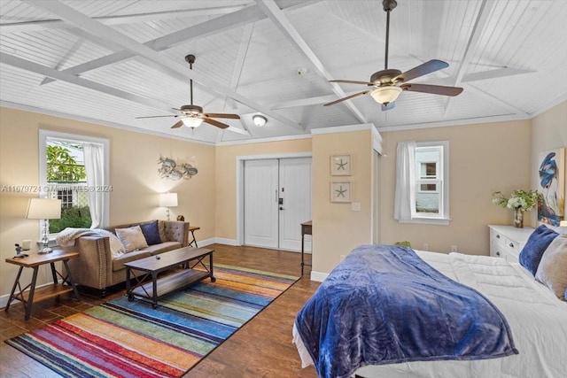 bedroom featuring dark wood-type flooring, ceiling fan, a closet, and lofted ceiling with beams