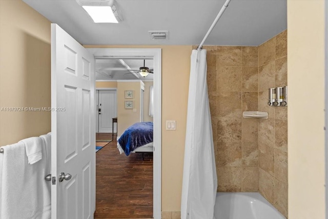 ensuite bathroom featuring ensuite bath, wood finished floors, visible vents, and shower / bathtub combination with curtain