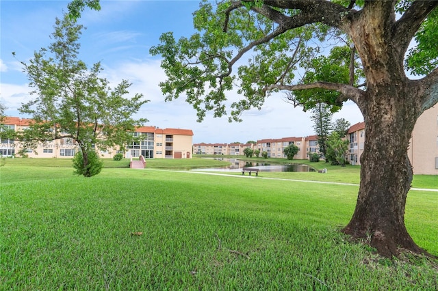 view of home's community featuring a yard and a water view