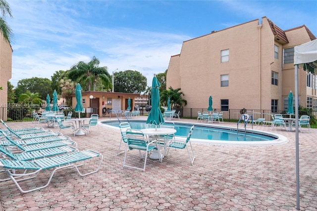 view of swimming pool with a patio