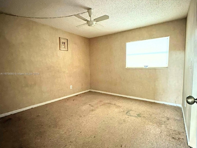 unfurnished room featuring a textured ceiling, carpet flooring, and ceiling fan