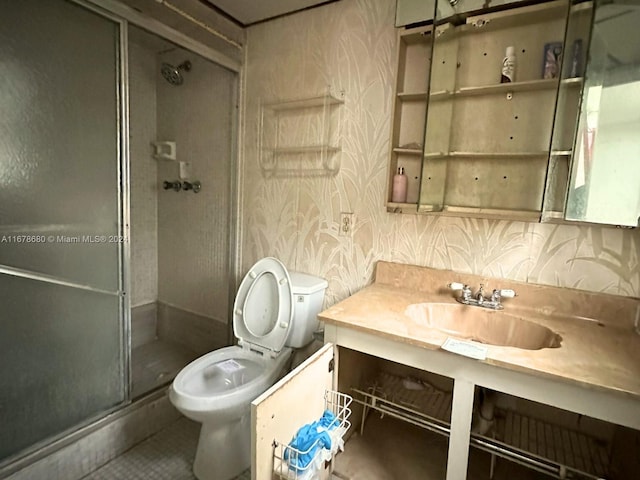 bathroom with vanity, tile patterned floors, toilet, and an enclosed shower