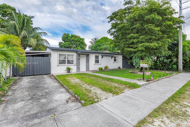 single story home featuring a front lawn