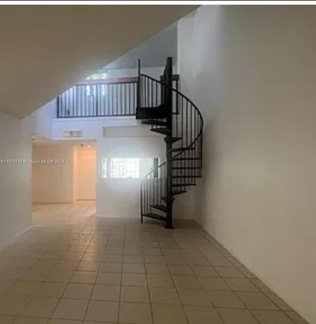 stairs featuring tile patterned flooring