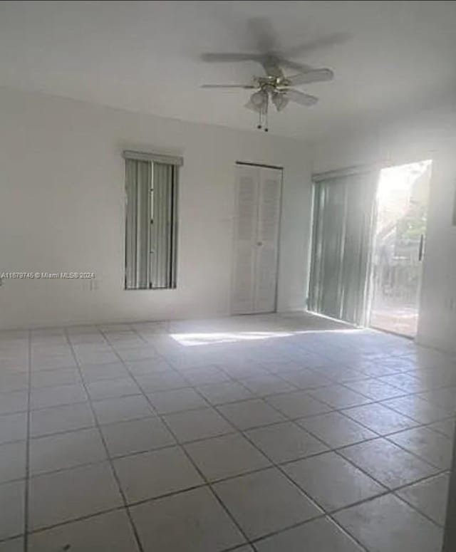 empty room with tile patterned floors and ceiling fan