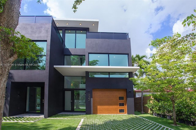 rear view of property featuring a lawn