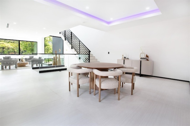 dining space featuring a raised ceiling