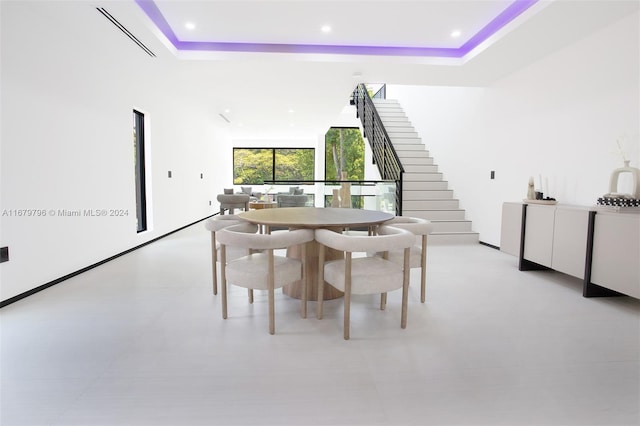 dining area with a tray ceiling