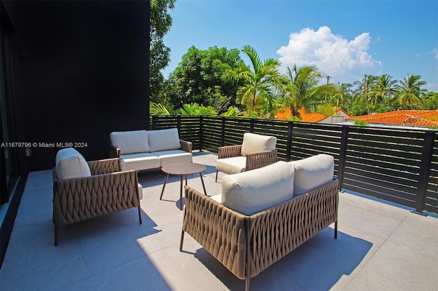 view of patio with outdoor lounge area and a balcony