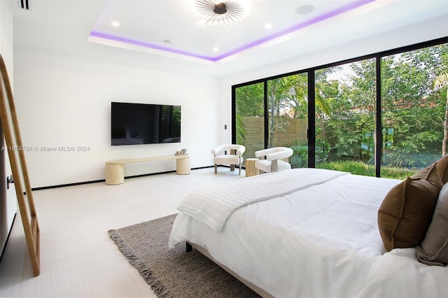 bedroom featuring carpet and a raised ceiling