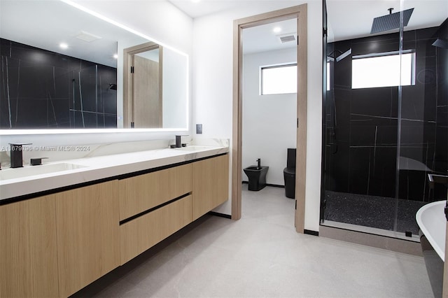 bathroom with an enclosed shower, vanity, toilet, and a bidet