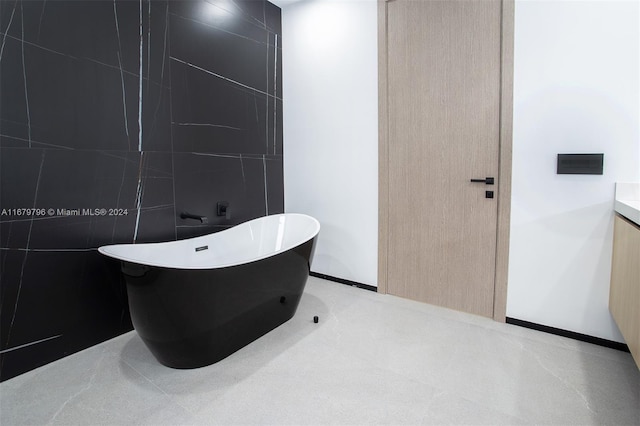 420 SW 15th Rd, Miami, FL 33129 - bathroom featuring a freestanding tub, vanity, and tile walls