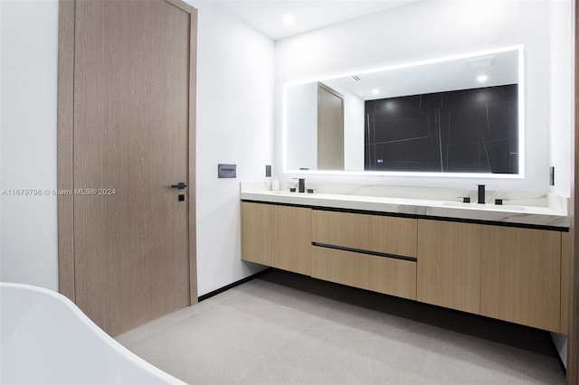 bathroom featuring a washtub and vanity