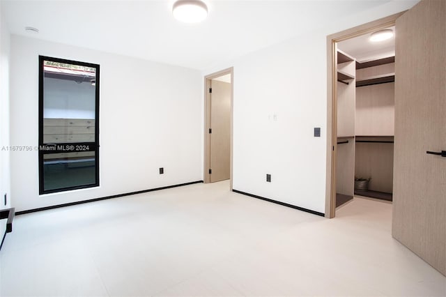420 SW 15th Rd, Miami, FL 33129 - unfurnished bedroom featuring a walk in closet and a closet