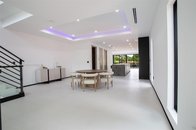 unfurnished dining area with a raised ceiling