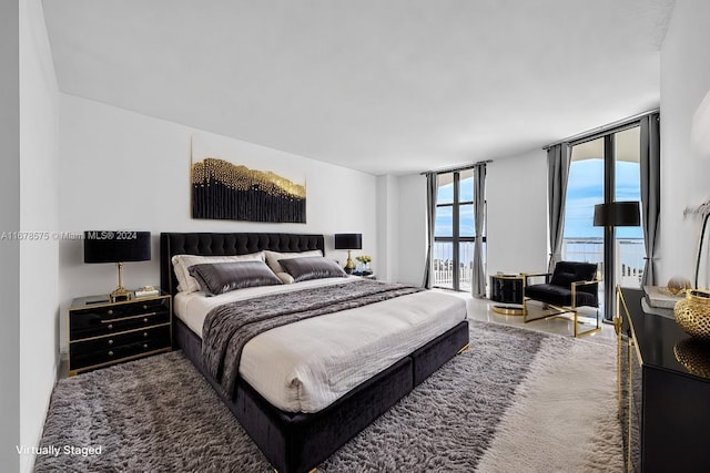 bedroom featuring hardwood / wood-style flooring and floor to ceiling windows