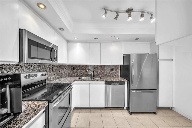 kitchen featuring crown molding, sink, light tile patterned flooring, white cabinetry, and stainless steel appliances