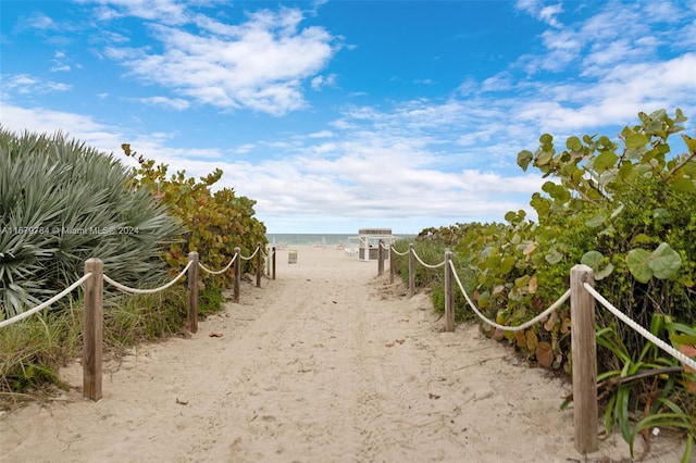 exterior space featuring a water view and a beach view