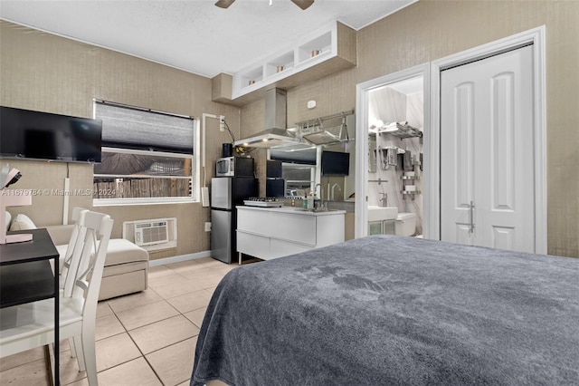 tiled bedroom featuring a wall mounted air conditioner, a textured ceiling, stainless steel fridge, and ceiling fan